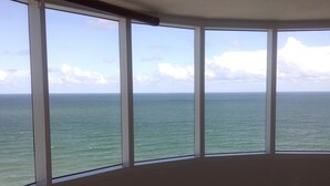 A bedroom with a large window overlooking the sea. - Direct Oceanfront Balcony, 23rd Floor, Peck Plaza Building, Daytona Beach Shores (Daytona Beach Shores)