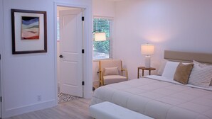 A bedroom with a bed, a chair, a lamp, and a window with blinds. - Cozy Arlington Home • Minutes to AT&T & Globe Life (Arlington)