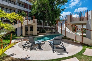 A pool area with lounge chairs and a staircase. - Loch Collection Tulum (Tulum)
