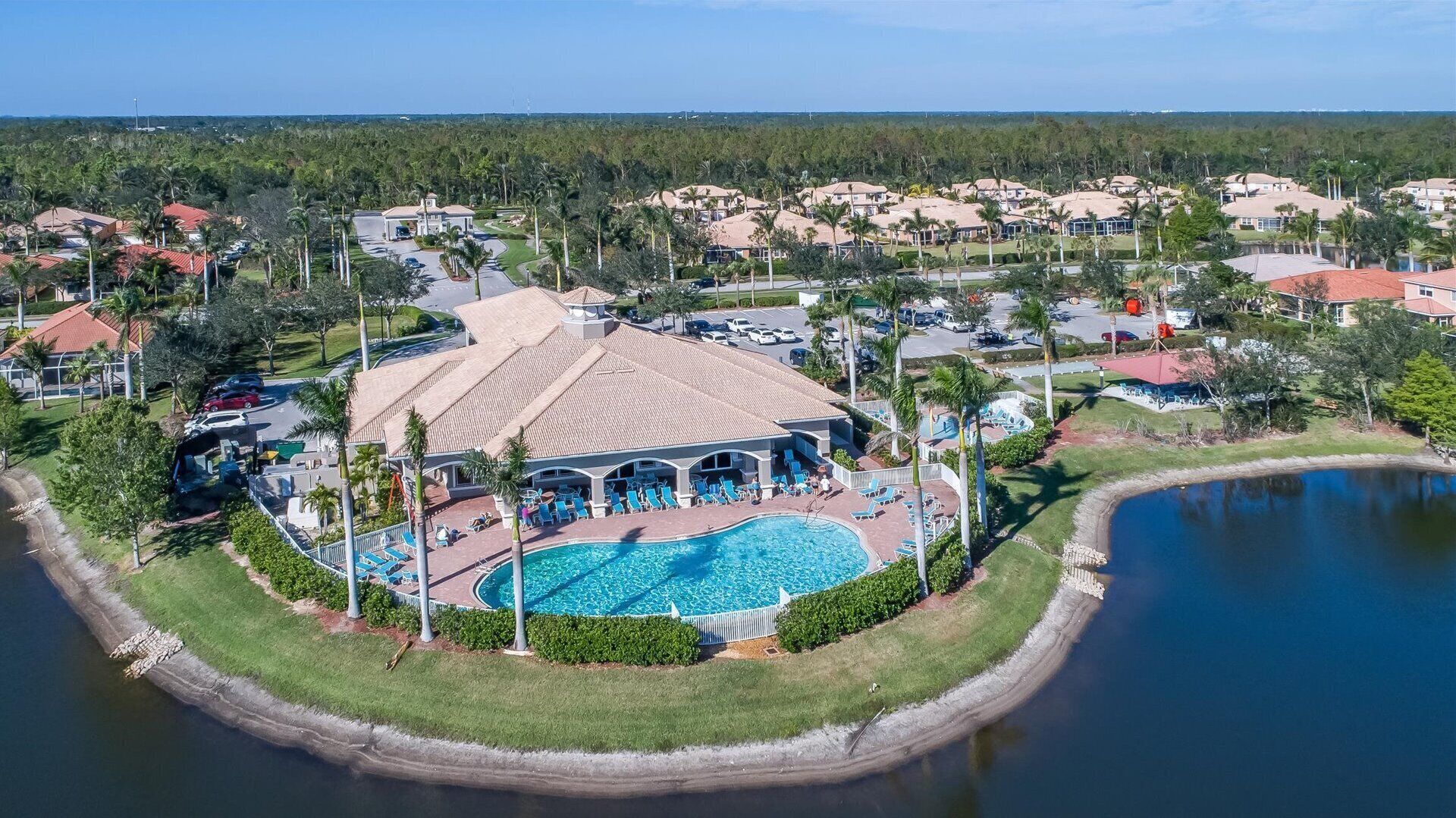 A resort with a central pool, multiple guest rooms, and a surrounding natural landscape.