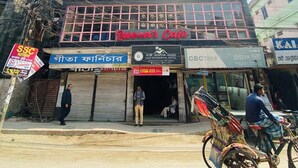 A multi-story building with a sign for 'Queen's Cafe' on the ground floor. - Gazi Residential Hotel Chandpur (Chandpur)