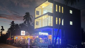 A modern building with a restaurant named 'Stargazer' and a sign for 'Stargazer'.