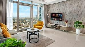 A modern living room with a large TV, a yellow armchair, and a view of the city through large windows. - Spectacular Burj View from Infinity Pool (Dubai)