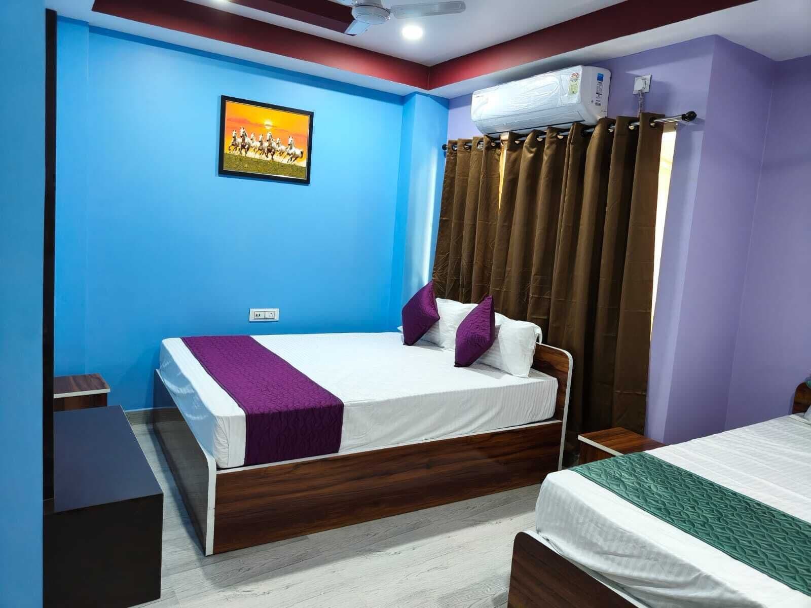 A bedroom with a bed, a bedside table, a wardrobe, and a ceiling fan.