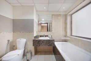 Ein Badezimmer mit Toilette, Waschbecken und Badewanne.