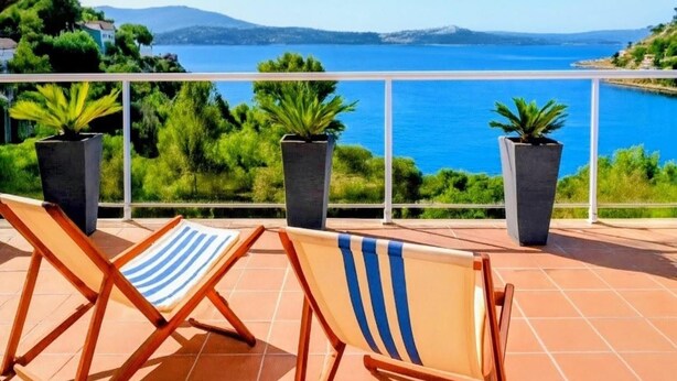 A terrace with two sun loungers and potted plants, overlooking a coastal landscape with mountains in the distance. - Beautiful Villa Martin AV-88 (Roses)