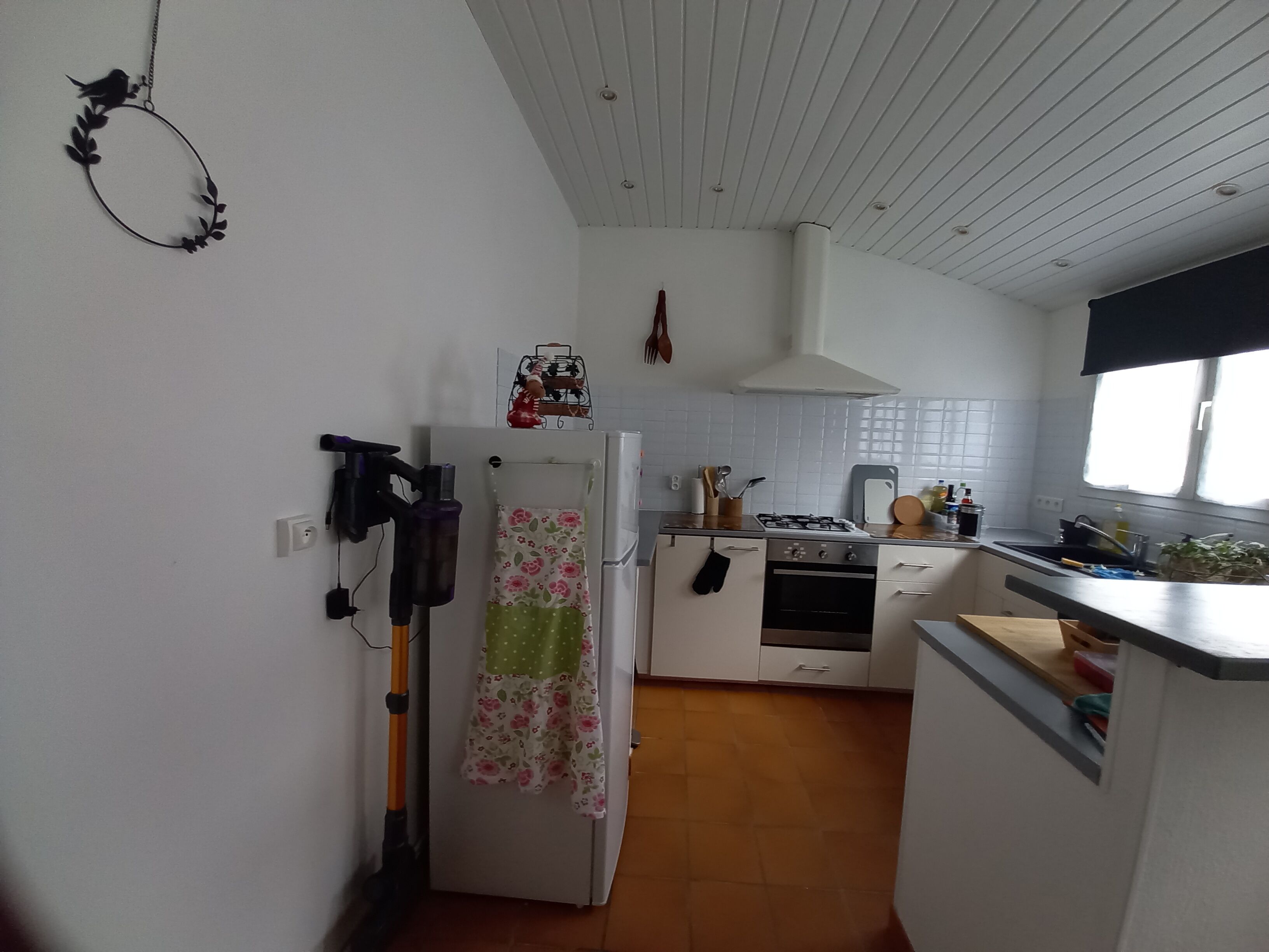 A kitchen with white cabinets, a stove, oven, and a sink.