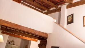 A staircase with exposed wooden beams, a white wall, and a framed picture. - Lovely apartment for 6 guests with A/C, WIFI, pool, TV and pets allowed, close to Florence (Impruneta)