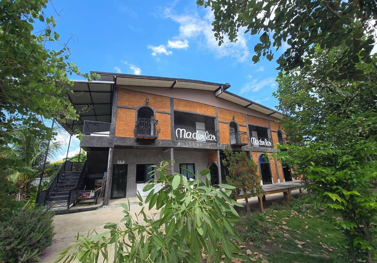 A two-story building with the name 'Madelmar' displayed on the facade.