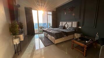 Luxury Studio Suite, Balcony, City View | In-room safe, desk, laptop workspace, blackout curtains