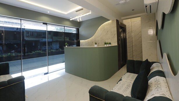 A modern reception area with a curved counter, seating, and a large glass window offering a view of the street. - Adkar Residency Gorai Borivali West  (Mumbai)