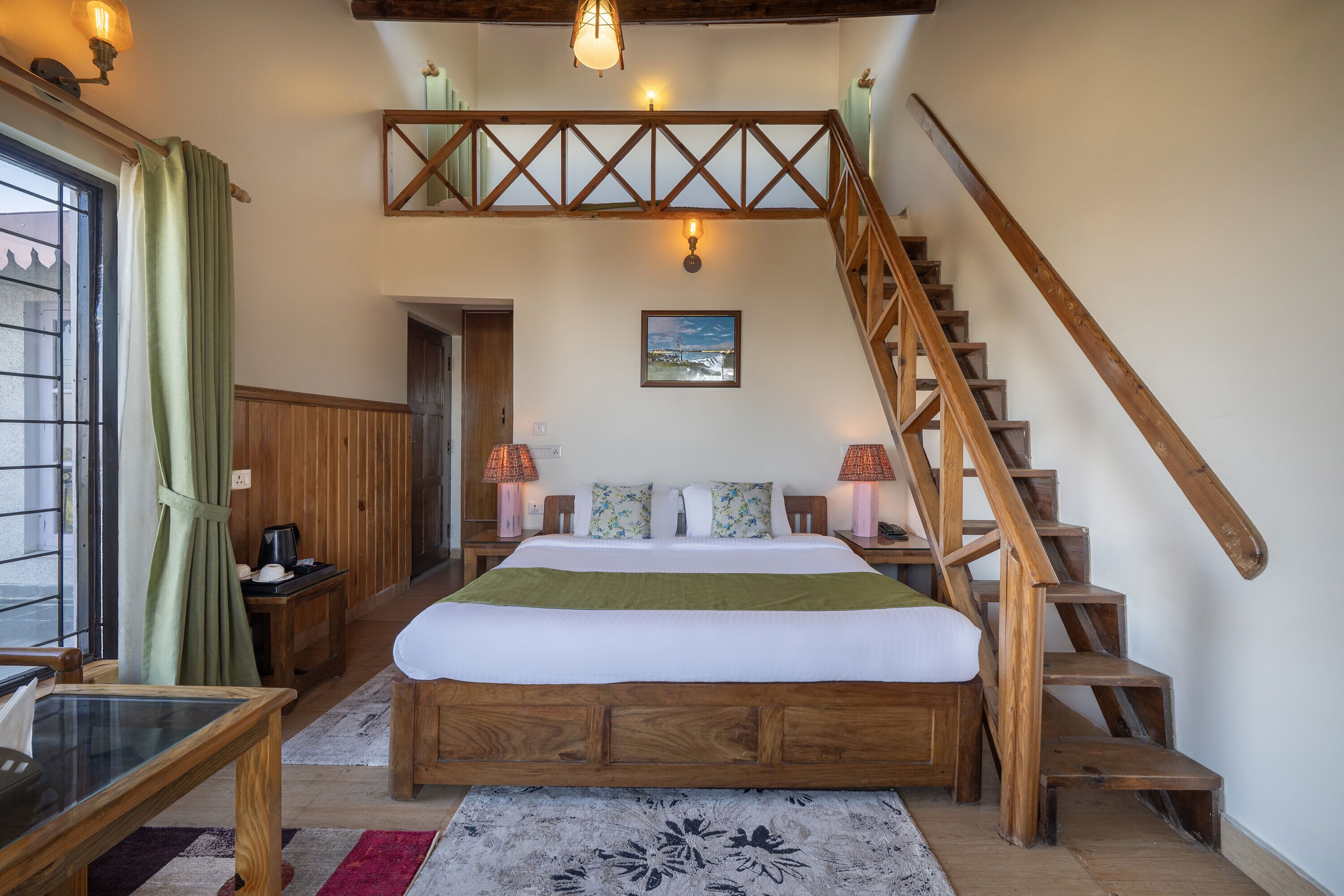 A bedroom with a wooden bed, a staircase, a view of the outside, and a painting on the wall.