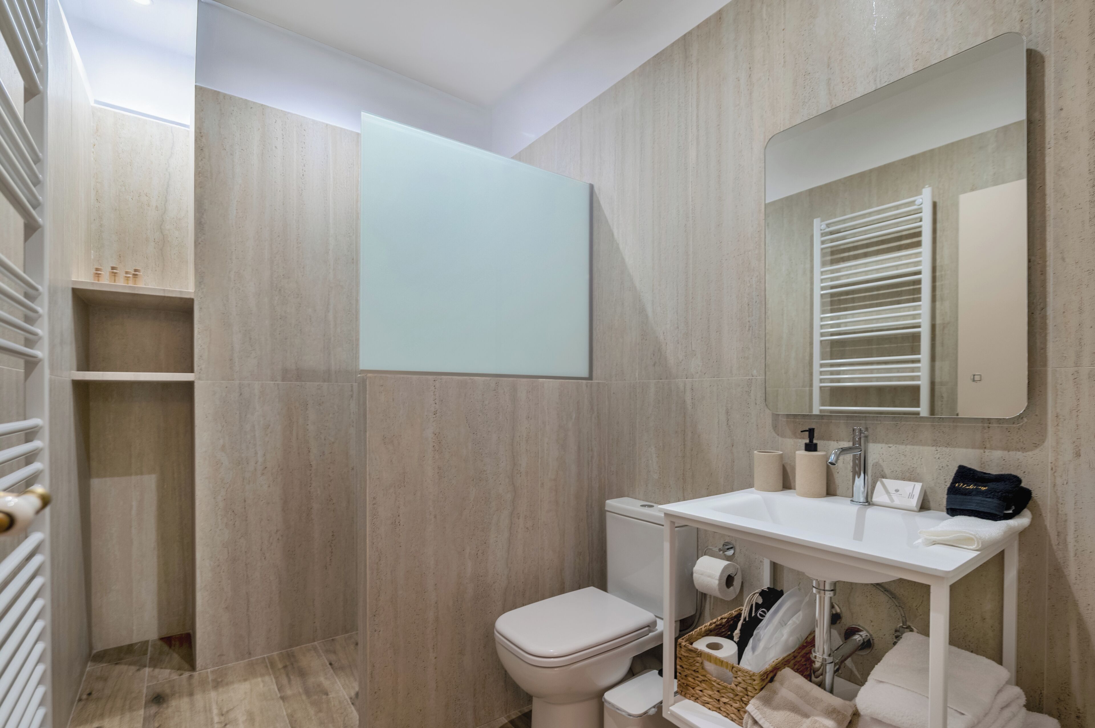 A modern bathroom with a toilet, sink, and shower area.