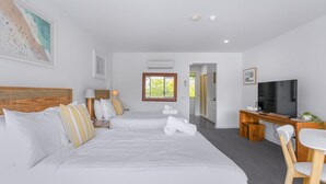 A hotel room with two beds, a TV, a desk, and a chair. - Bay View: Ocean Breeze (Lorne)