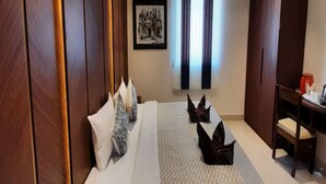 A hotel room with a bed, a desk, and a wardrobe. - Eennra Maanikko (Krishnanagar)