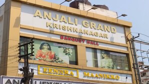 A building with a sign for 'Anjali Grand Krishnanagar Banquet Hall' and 'Anjali Jewellers' below. - Eennra Maanikko (Krishnanagar)