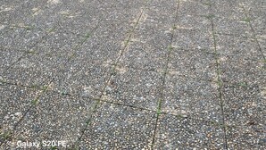 A residential building with a paved driveway, a balcony with metal bars, and a window with patterned curtains. - QUIET, SECURE F3 RENTAL WITH GARAGE (Nîmes)
