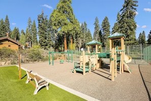 A playground with a slide, climbing structures, and a bench. - Rocky Ridge Unit #35 (Tahoe City)