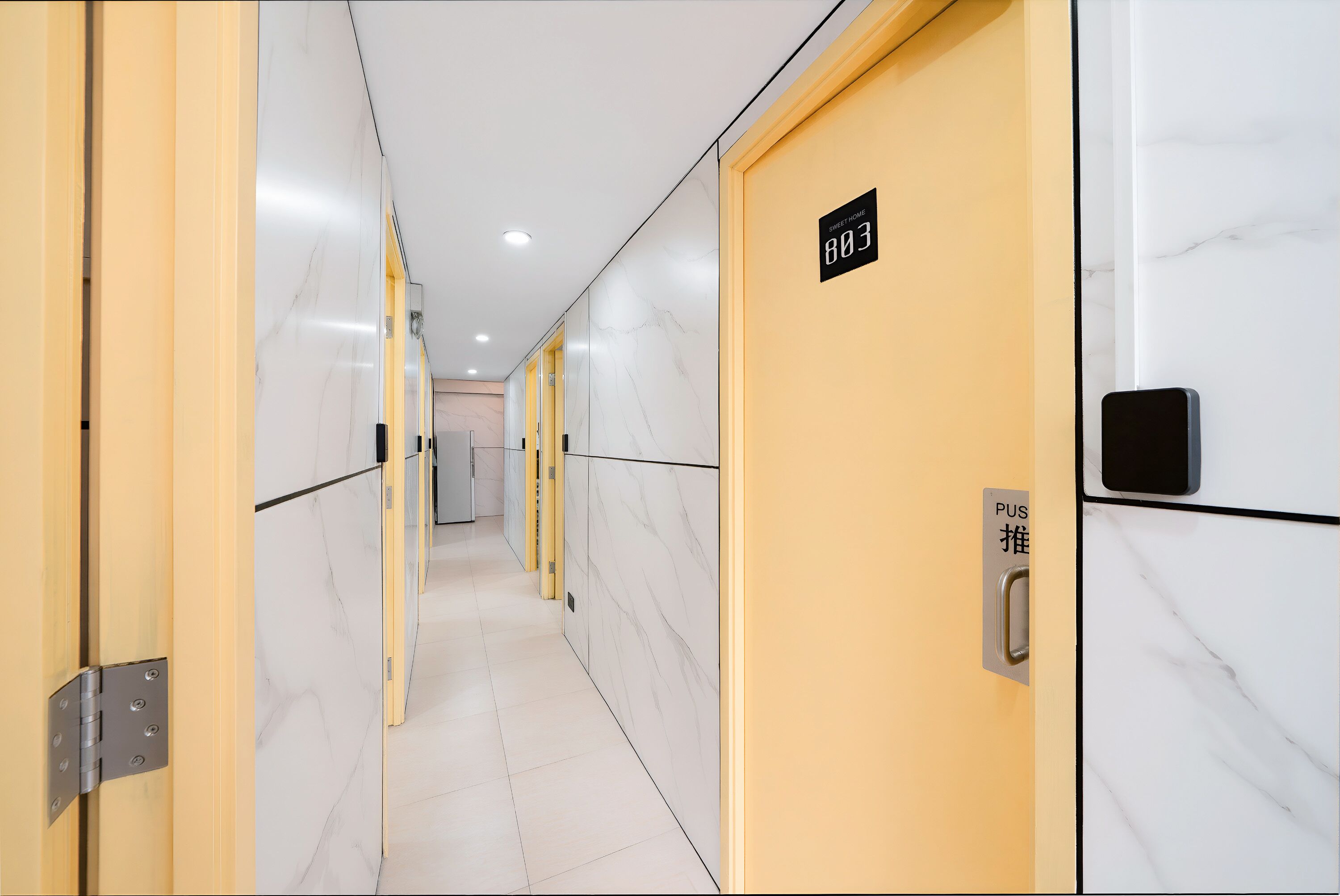 A hotel corridor with marble walls and doors numbered 803 and 804.