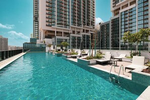 Outdoor pool, open 7:00 AM to 10:00 PM, pool umbrellas, sun loungers - Sobha Suites by Hostiva - Burj View (Dubai)