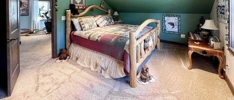 Ein Schlafzimmer mit einem Holzbett, einem kleinen Tisch und einem Stuhl.