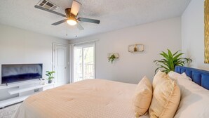 A bedroom with a bed, a ceiling fan, a TV, and a window. - Pet-friendly Retreat w/ Yard, 12 Mi to Dtwn Tulsa (Tulsa)