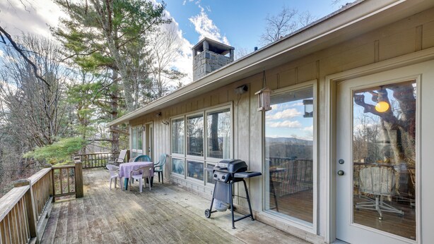 A covered deck with a grill, outdoor seating, and a view of the surrounding forest. - Ski, Hike & Unwind: Mtn-view Gem w/ Deck in Boone (Boone)