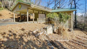A lodge with a covered porch, a stone fireplace, and a view of the surrounding forest. - Ski, Hike & Unwind: Mtn-view Gem w/ Deck in Boone (Boone)