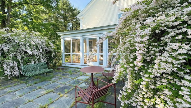 A covered patio with a stone floor, a wooden bench, a table, and chairs. - Close to Copake Lake! 4-season Escape w/ Sauna (Copake)