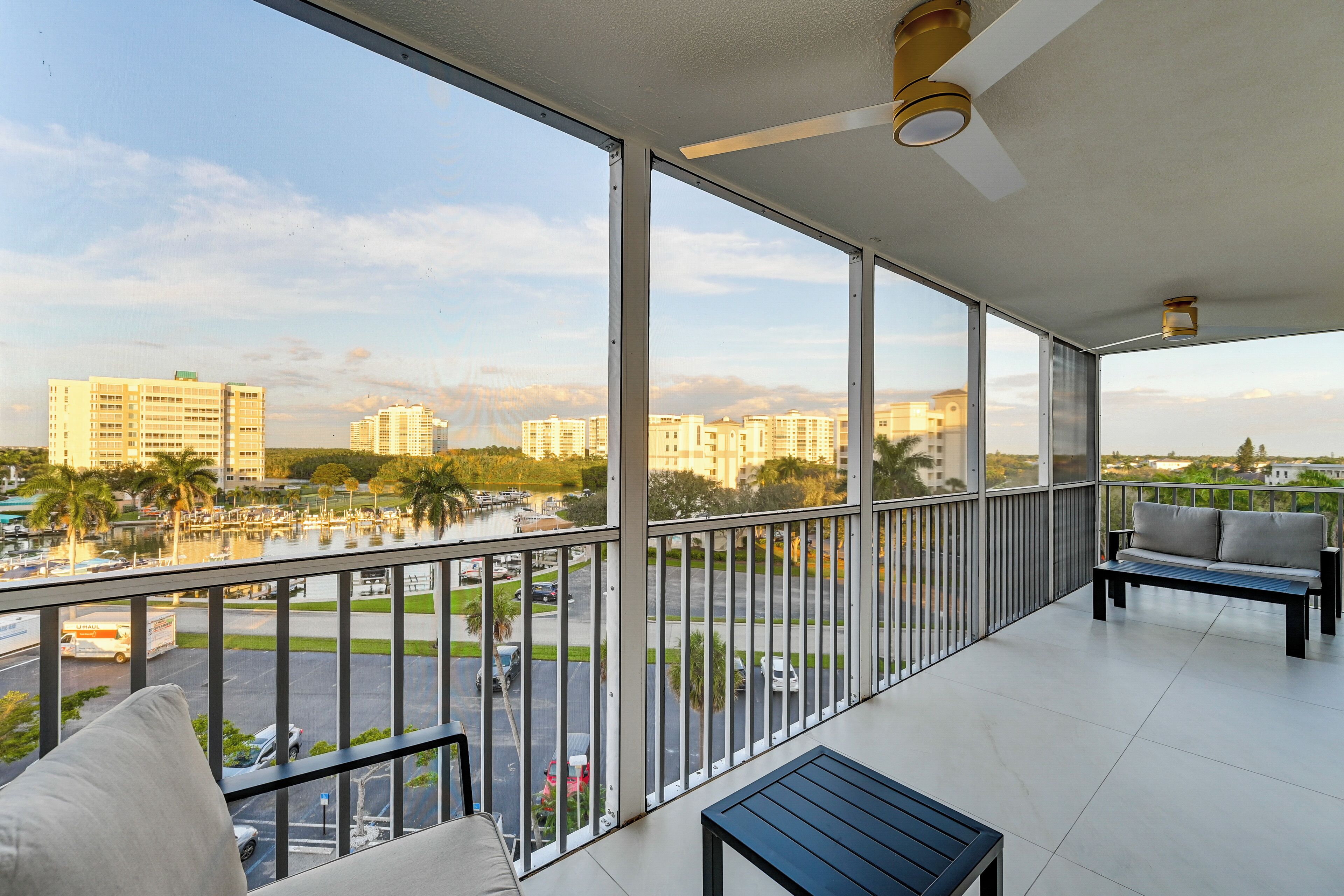 A balcony with a view of a marina and buildings.