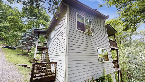A two-story house with a wooden deck and a covered porch. - Mtn-view Deck! Maggie Valley Cabin, 8 Mi to Skiing (Maggie Valley)