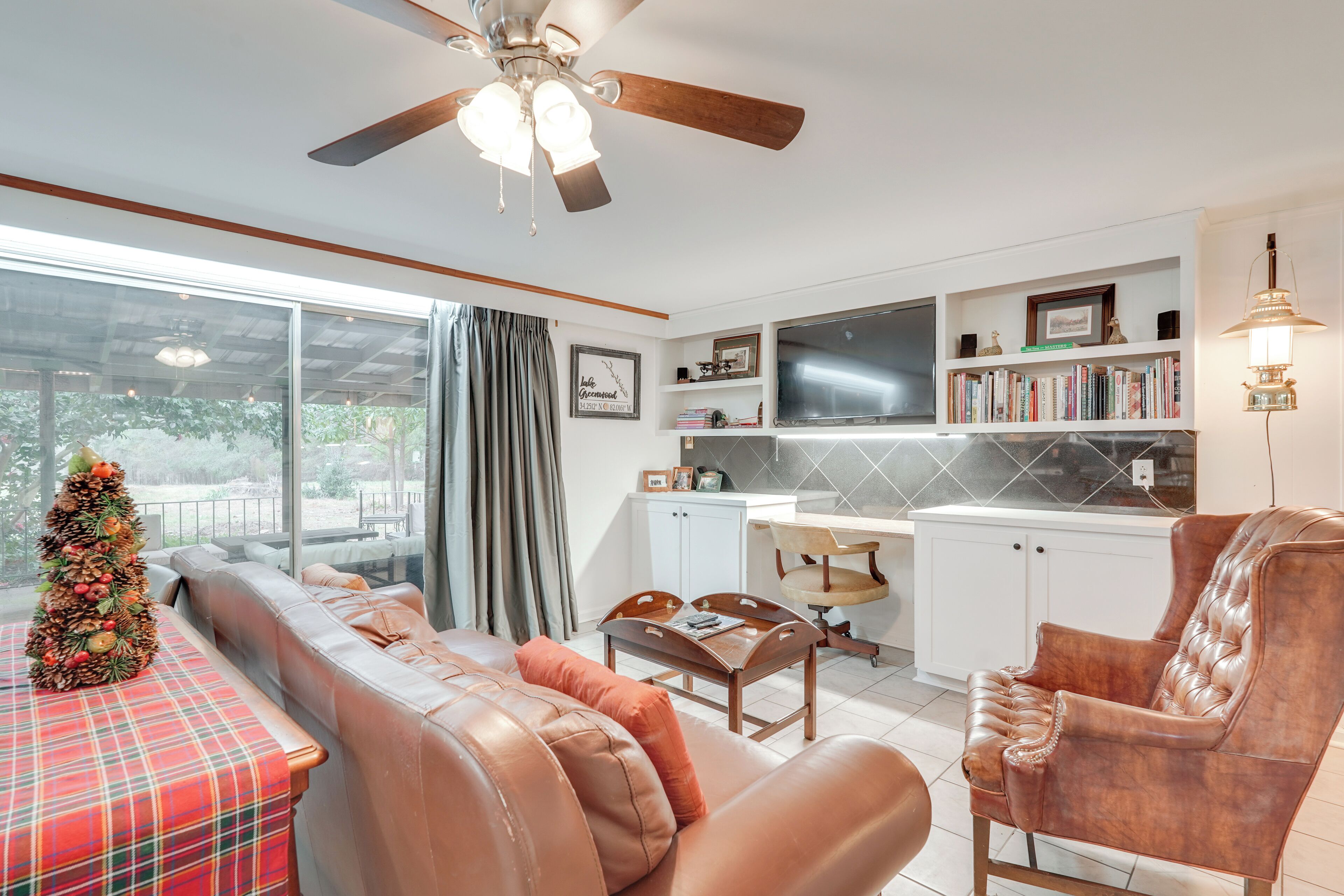 A living room with a sofa, a coffee table, a fireplace, and a bookshelf.