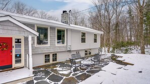 A house with a red door, stone patio, and outdoor seating. - 5 Mi to Mt Snow: Secluded Family Home w/ Game Area (West Dover)