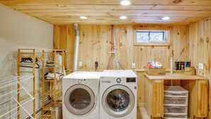 A laundry room with two washing machines, a drying rack, and a small window. - 5 Mi to Mt Snow: Secluded Family Home w/ Game Area (West Dover)