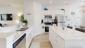 A modern kitchen with white cabinetry, a built-in dishwasher, a microwave, and a stove. - 4BR Lakefront Retreat w/ Furnished Deck, Dock (Salisbury)