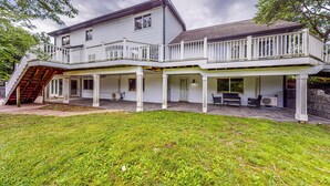 A two-story house with a covered porch, a staircase, and a well-maintained lawn. - River Access! Couples Retreat on Working Homestead (Woodburn)