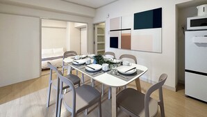 A modern dining area with a white table set for four, surrounded by grey chairs. A white refrigerator is to the right, and a bed is visible in the background. - Dai3Kuboi 405 (Hiroshima)
