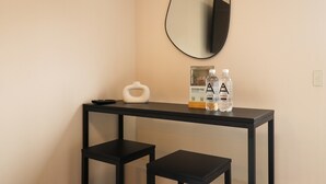A small, modern room with a black console table, a white decorative object, and two bottles of water. - w Fascinating Loft in the Heart of Miraflores (Lima)
