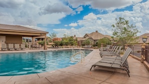 A swimming pool with lounge chairs, a covered seating area, and a clear sky. - Pebble Beach Retreat At Coral Ridge Resort 4 Bedroom Townhouse (Washington)