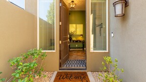 A house entrance with a welcome mat, a door, and a light fixture. - Pebble Beach Retreat At Coral Ridge Resort 4 Bedroom Townhouse (Washington)