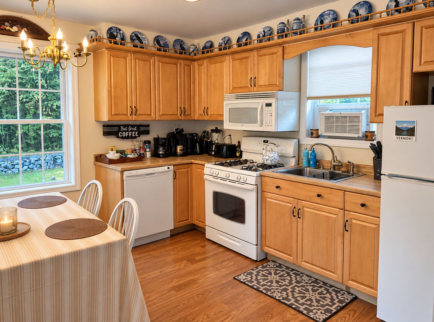 A kitchen with wooden cabinets, a stove, a microwave, and a refrigerator.