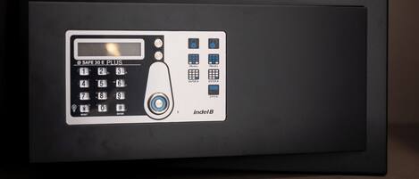 A black safe with a keypad, a PIN entry slot, and a lock mechanism.