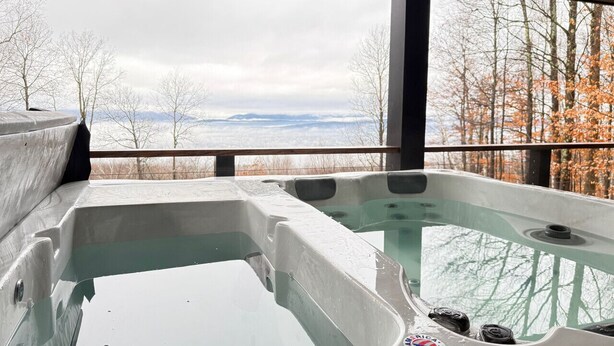 A hot tub area with a view of a forest and mountains. - Sunset Notch- Hot tub, Cold Plunge, Hiking, Views! (Mendon)