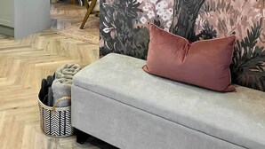 A modern kitchen with a dining area, a large mirror, and a sofa with a cushion. - The Fuller's Shed All Weather Couples Rural Retreat with Private Hot tub (Dadlington)
