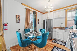 A modern kitchen with white cabinets, a stainless steel refrigerator, and a gas stove. - VIP LUX-2 Bedroom Apart-15 min NYC-Shared Parking (Fairview)