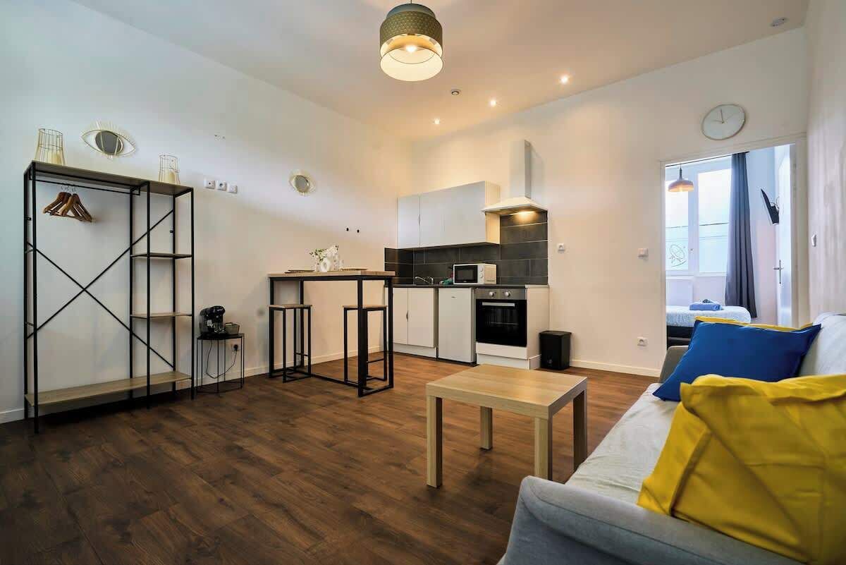 A modern apartment with a kitchen, dining area, and living room.