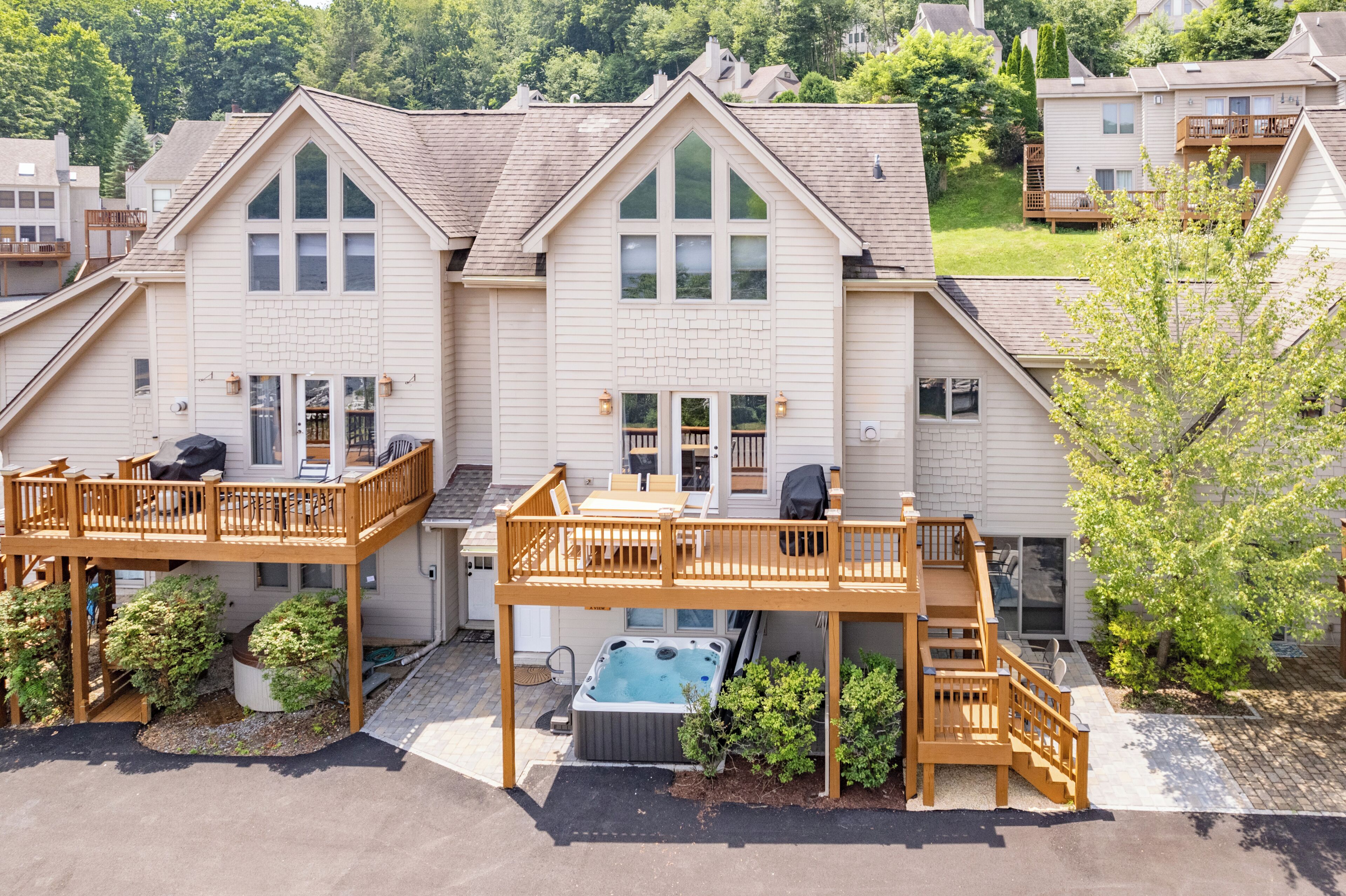 A residential building with a central courtyard, multiple decks, and a hot tub.