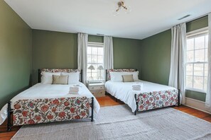 A bedroom with two beds, a window, and a nightstand. - Barrel Sauna, Hot Tub & Views (Roseland)