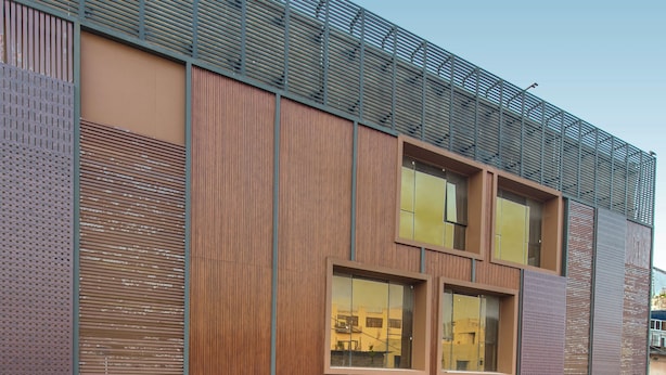 A modern building with multiple balconies, large windows, and a metal roof. - Kzar Park (Kolkata)