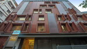 A modern building with a prominent entrance, multiple windows, and a sign indicating it is part of the KZAR PARK complex. - Kzar Park (Kolkata)